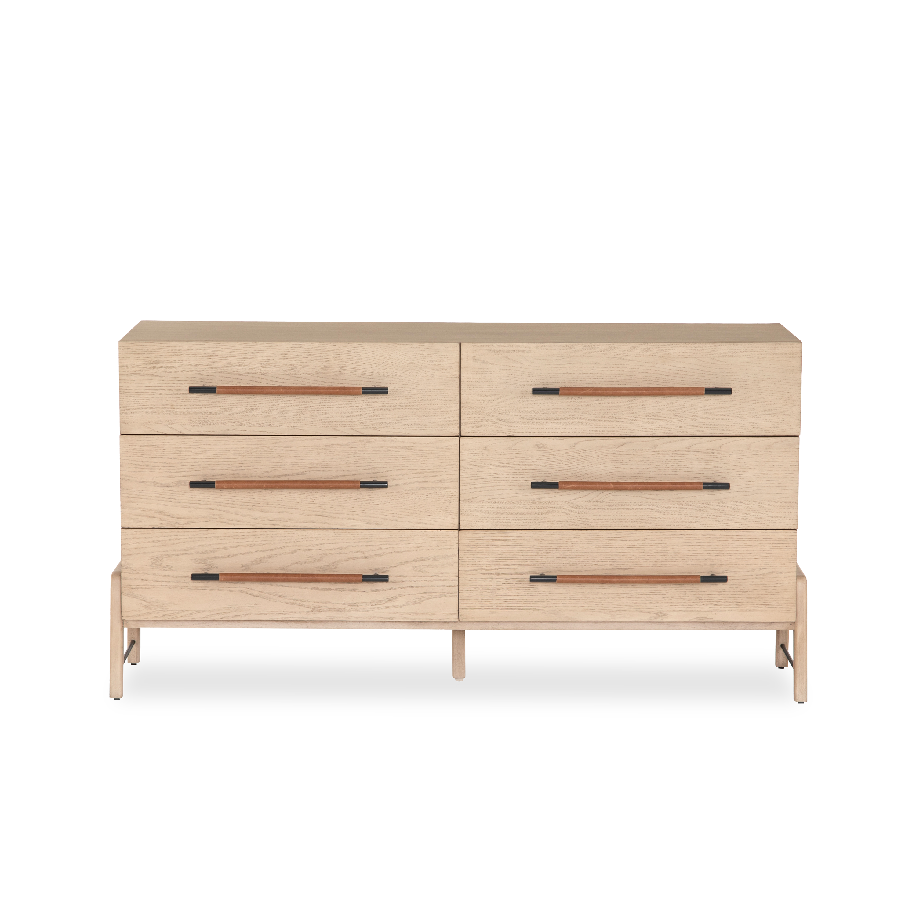 The Buckley Dresser features light-finished oak forming a clean silhouette for six spacious drawers with iron hardware wrapped in tan top-grain leather.