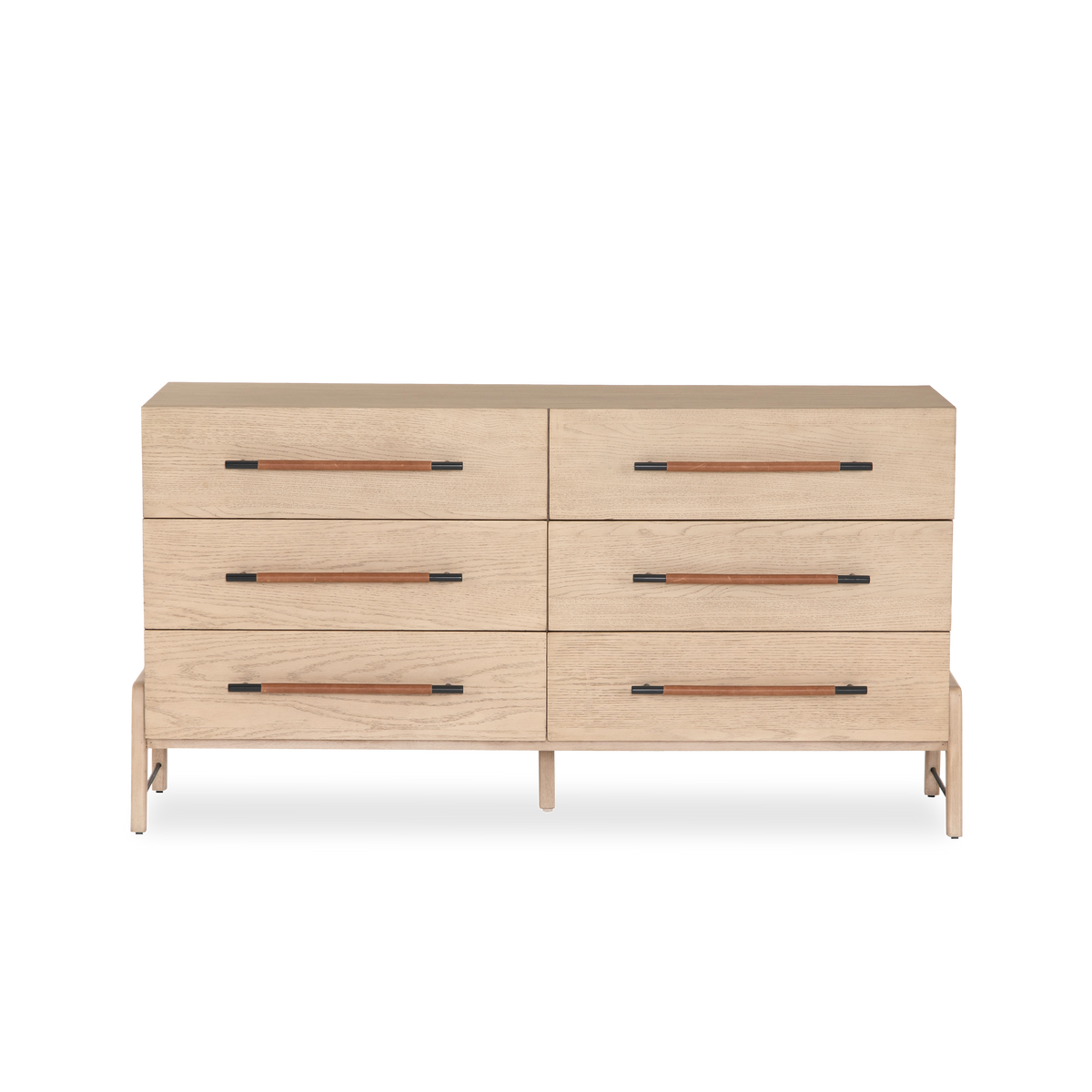 The Buckley Dresser features light-finished oak forming a clean silhouette for six spacious drawers with iron hardware wrapped in tan top-grain leather.