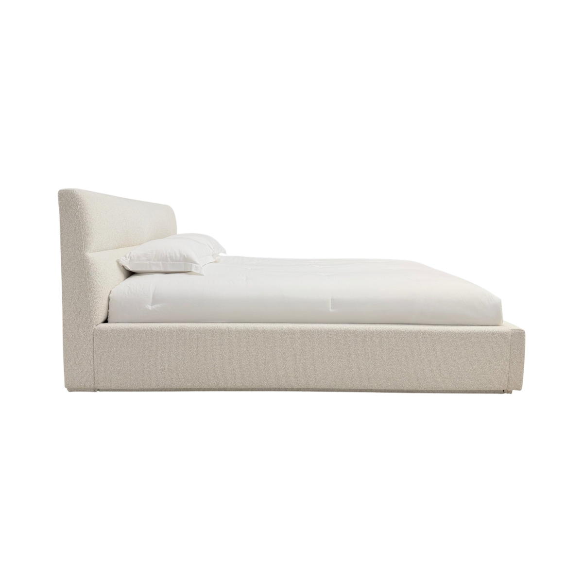 Side view of Pearson King Bed showing the low upholstered platform and gently reclined headboard in Lisa Cream.