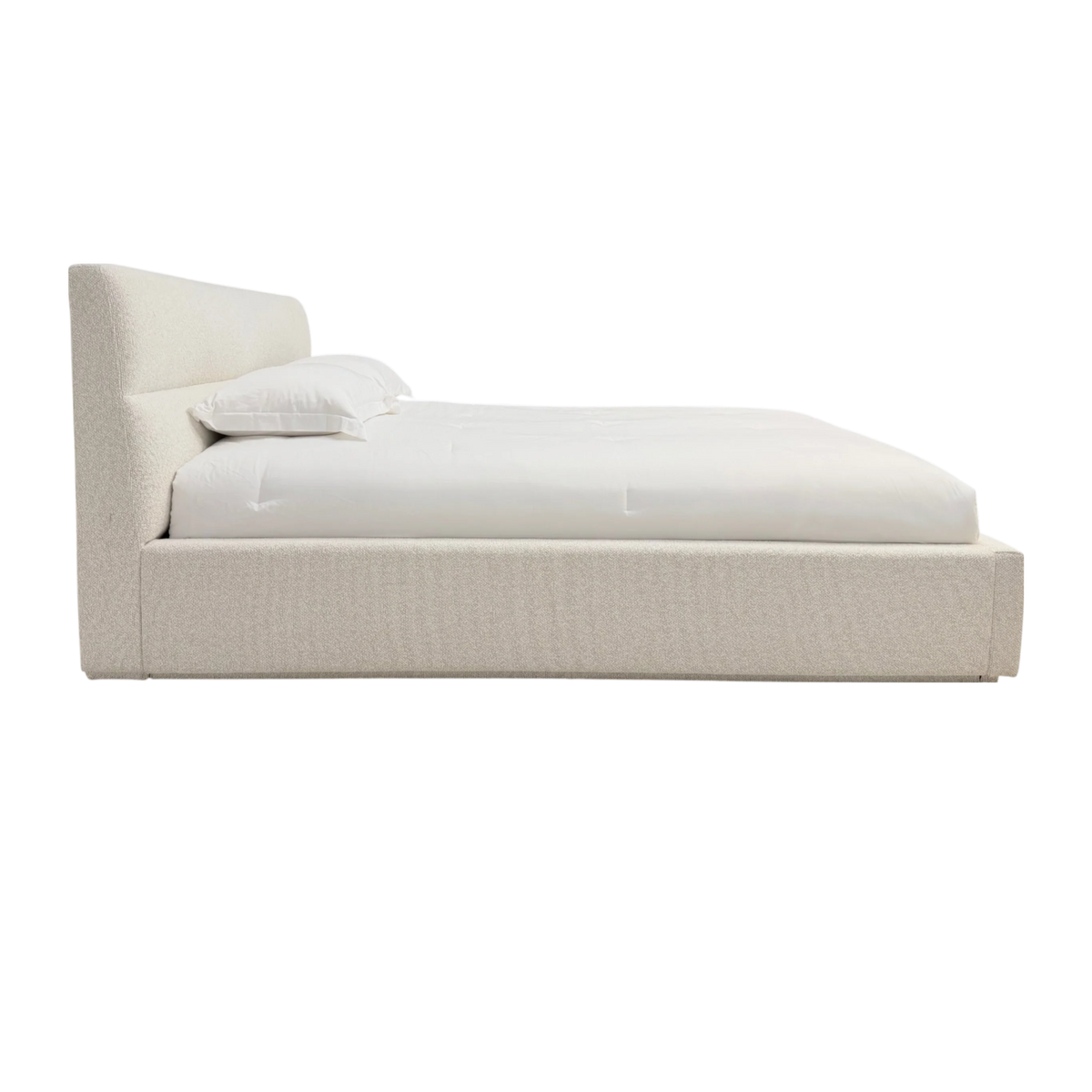 Side view of Pearson King Bed showing the low upholstered platform and gently reclined headboard in Lisa Cream.
