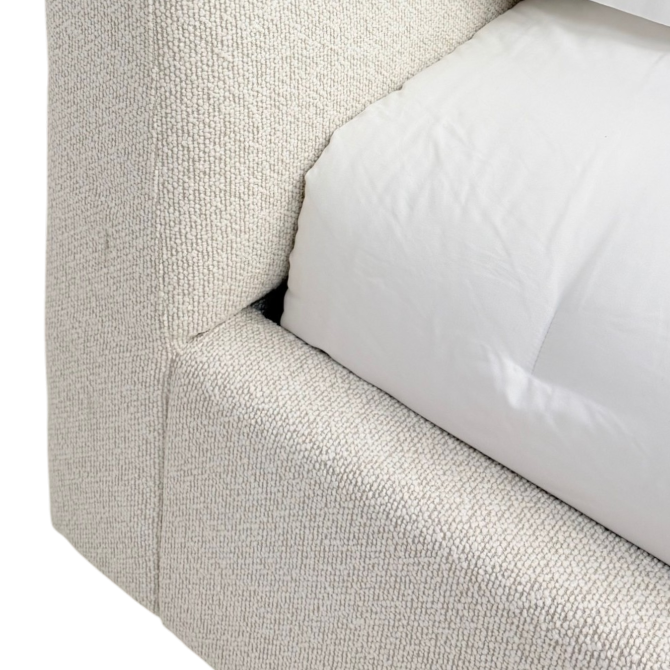 Close-up of Pearson King Bed headboard and side rail showing the nubby ivory upholstery texture.