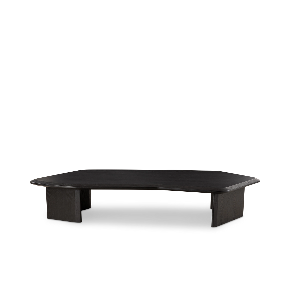 Gemini Coffee Table angled view in black ash, showing the low profile, beveled top edge, and paired slab legs casting a soft shadow.