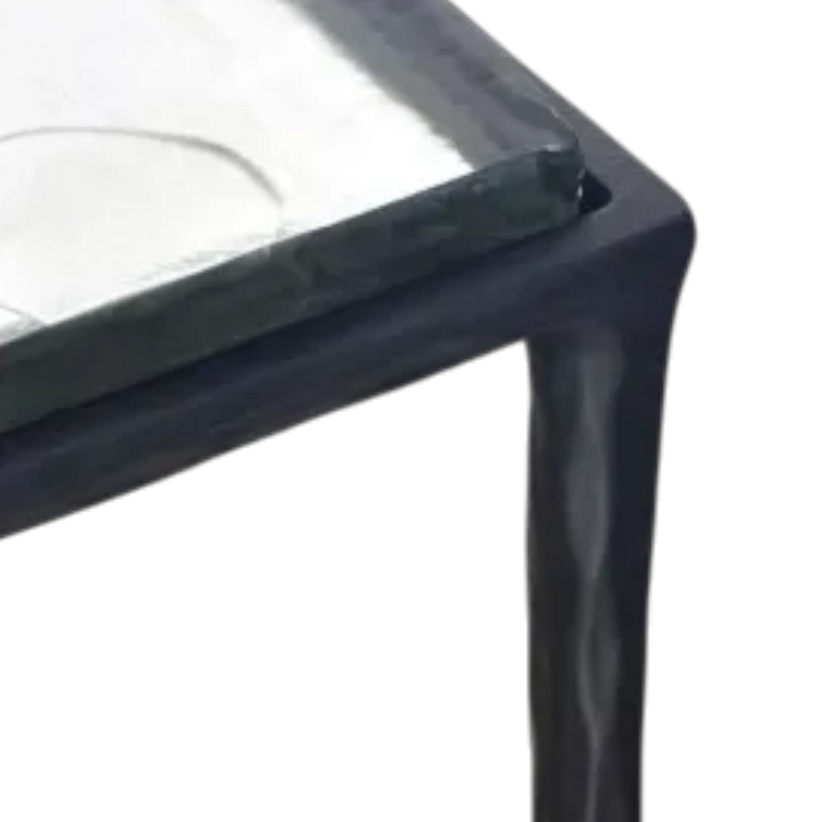Close-up of the Linea Side Table highlighting the frosted cast-glass edge, subtle natural swirls and the rippled texture of the dark iron frame.