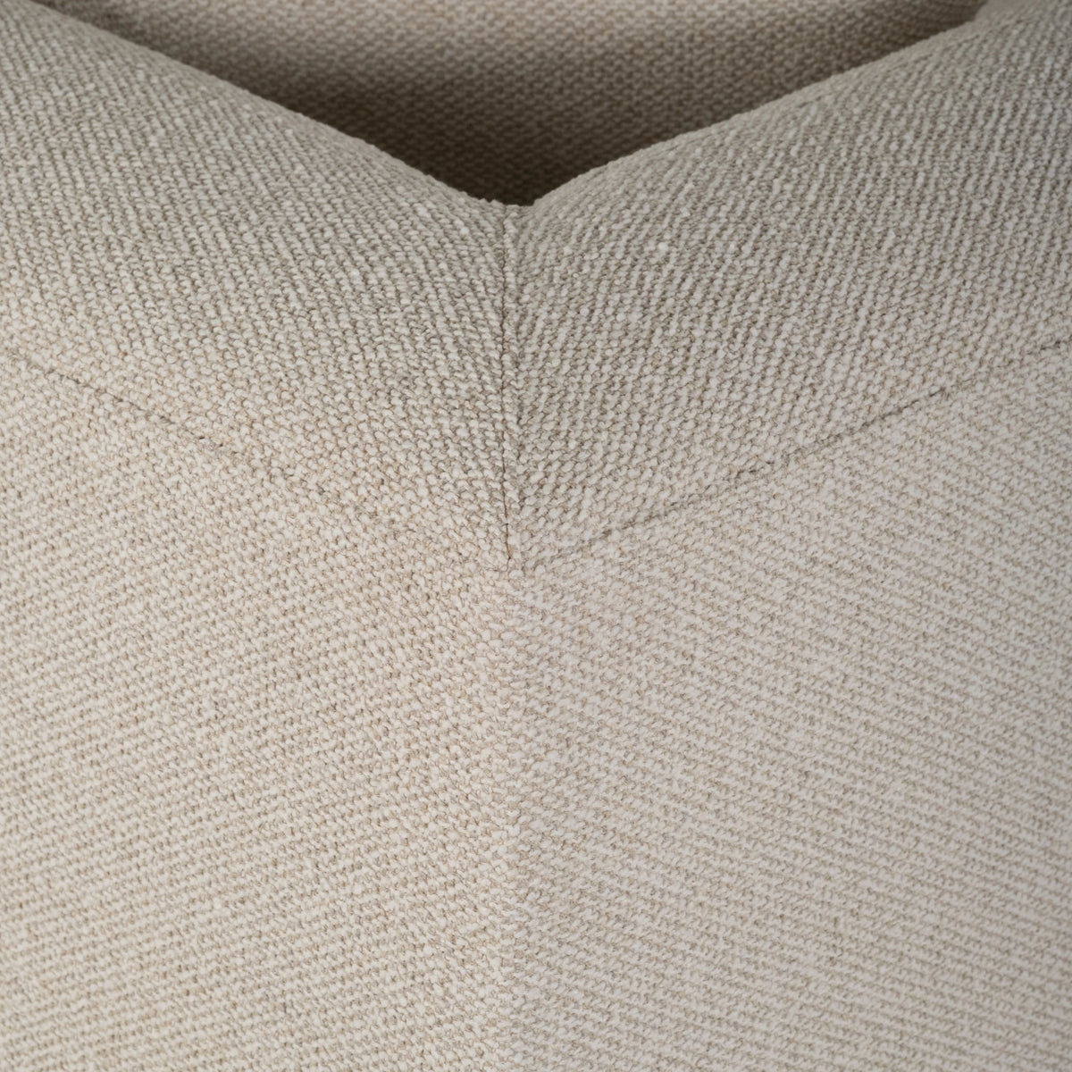 Close-up showing the mitered corner seam on the Arlo Modular Sectional in Oatmeal tweedy weave, with the weave running diagonally on each side of the seam.