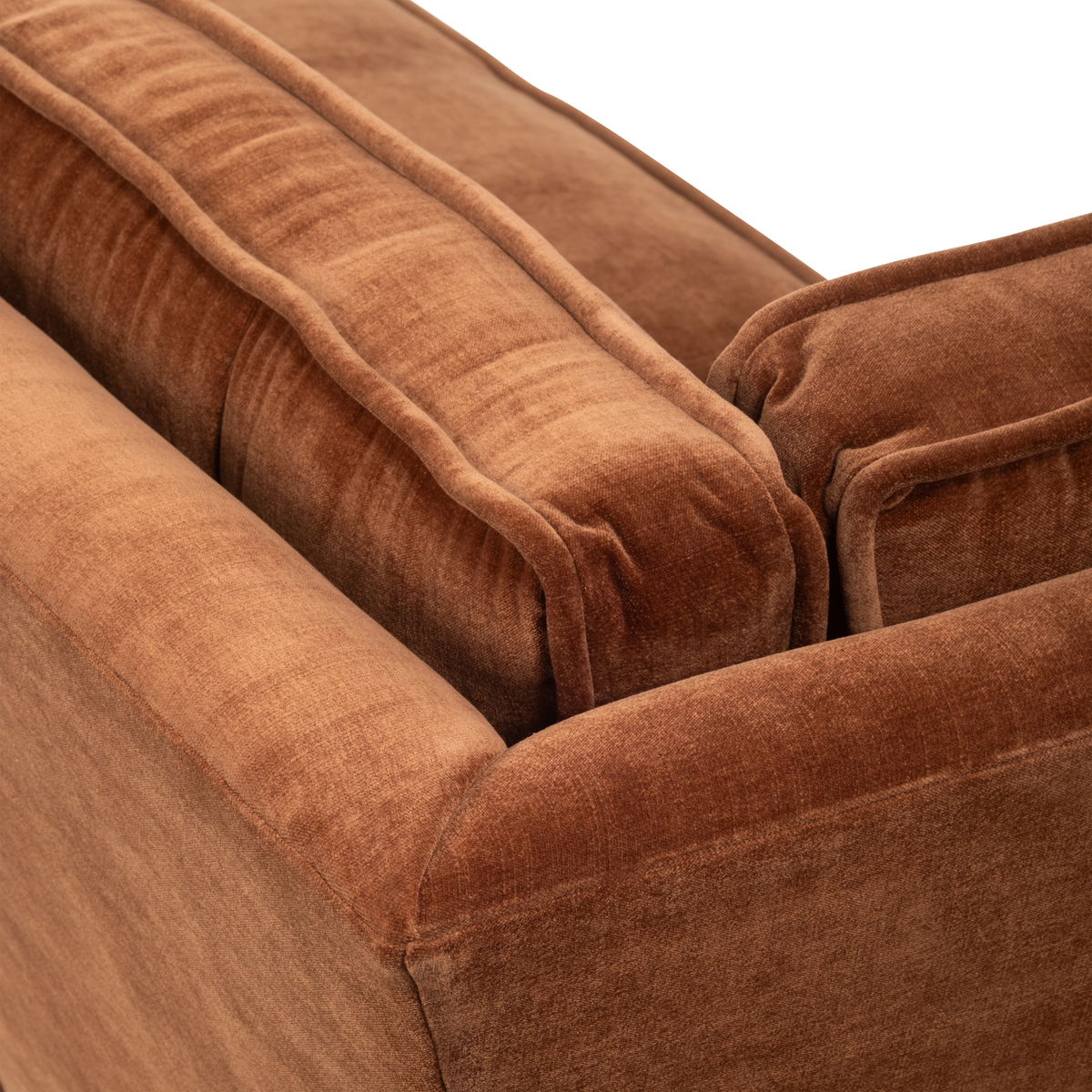 Detail view of the Loom Modular Sectional in rust chenille, highlighting the piped back cushion, the layered seat edge, and the slim angled side panel.