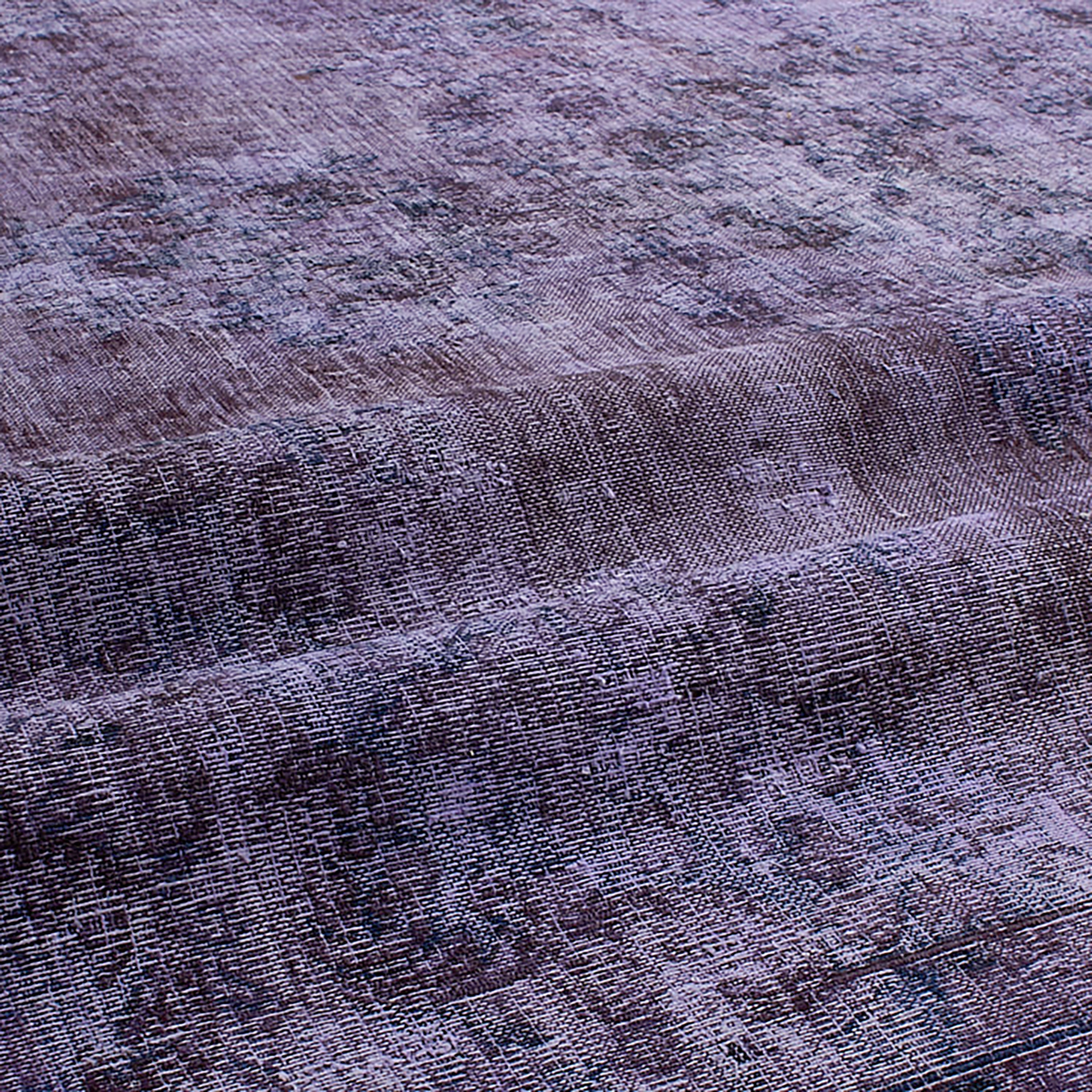 Antique Persian and Turkish rugs are stripped of their original colours, over-dyed and reborn, making each a one-of-a-kind piece.