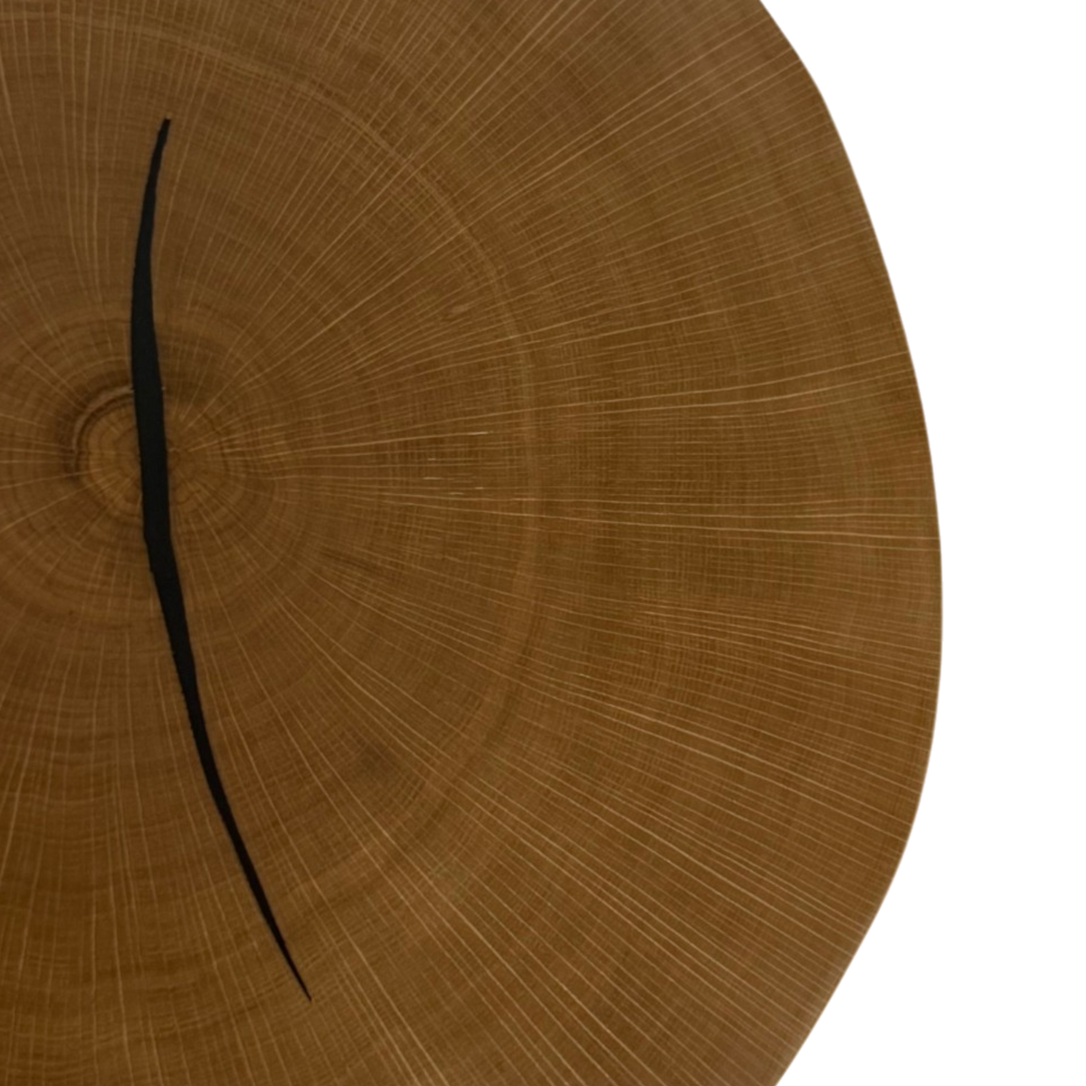 Wafer coffee table low. A close-up of a circular wooden coffee table  with visible wood grain, radial lines, and a thin black curved hand, shown against a white background.