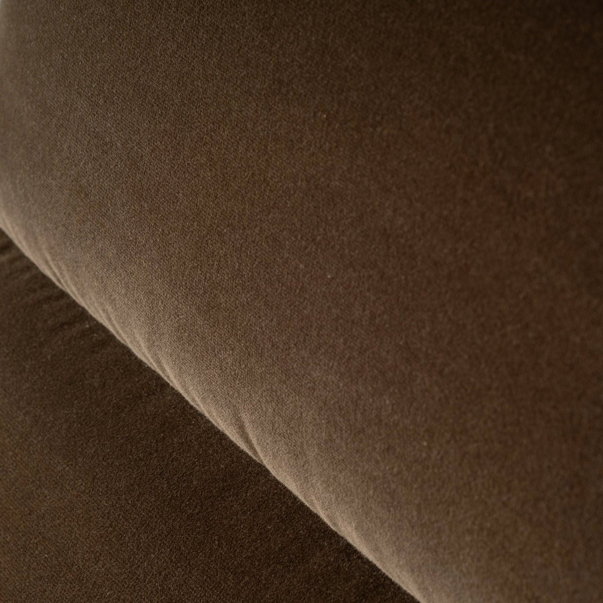 Close-up showing the soft, short nap of the Wallace Lounge Chair’s Olive Brown velvet, shifting from warm brown to deeper olive in the folds.