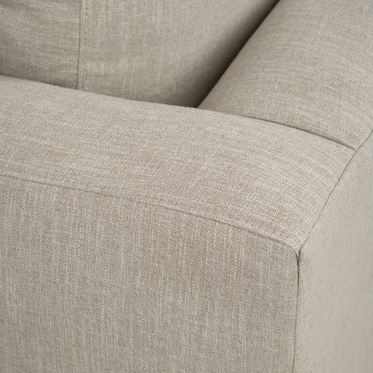 Close-up of the Beacon Chaise Sectional showing the softly textured neutral upholstery and tailored track arm.