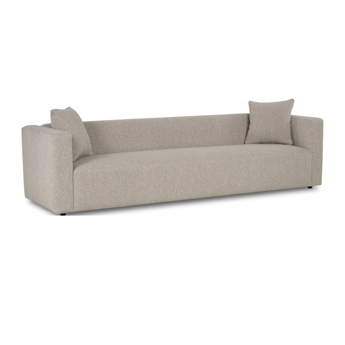 Angled view of the Ease Sofa in Pebble textured fabric, highlighting the low, tailored profile, the continuous seat, and short dark feet.