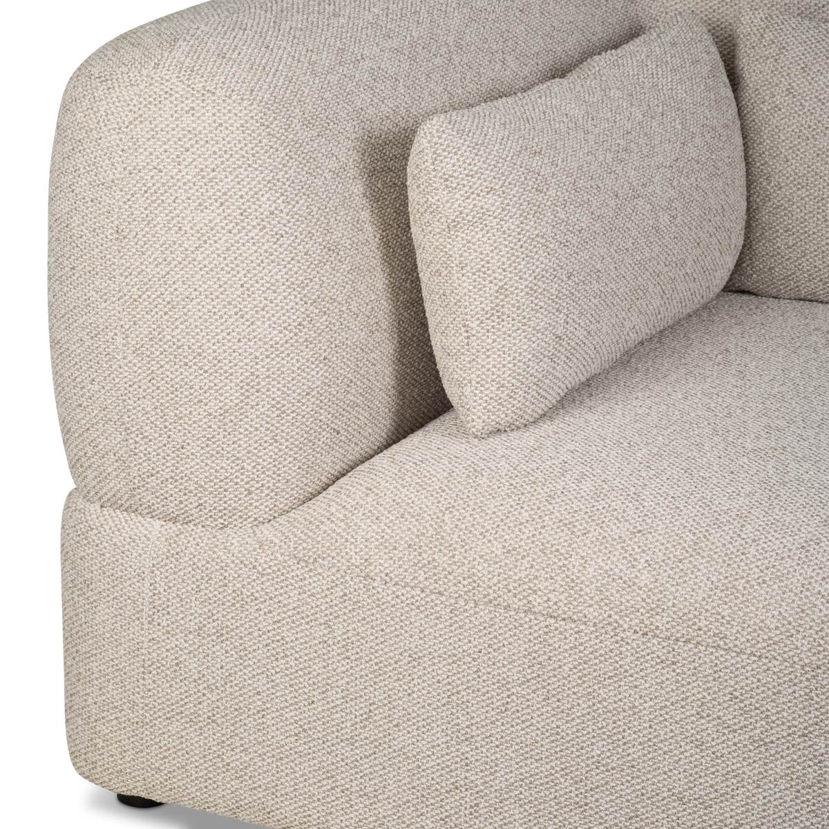 Close-up of the Duncan Modular Sectional’s rounded back and lumbar pillow in Oatmeal nubby woven fabric, with a clean curved seam at the seat edge.