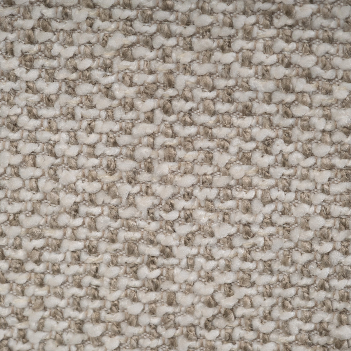 Close-up swatch of Oatmeal woven fabric on the Duncan Modular Sectional, showing creamy white and mushroom-taupe nubs over a tan base weave.