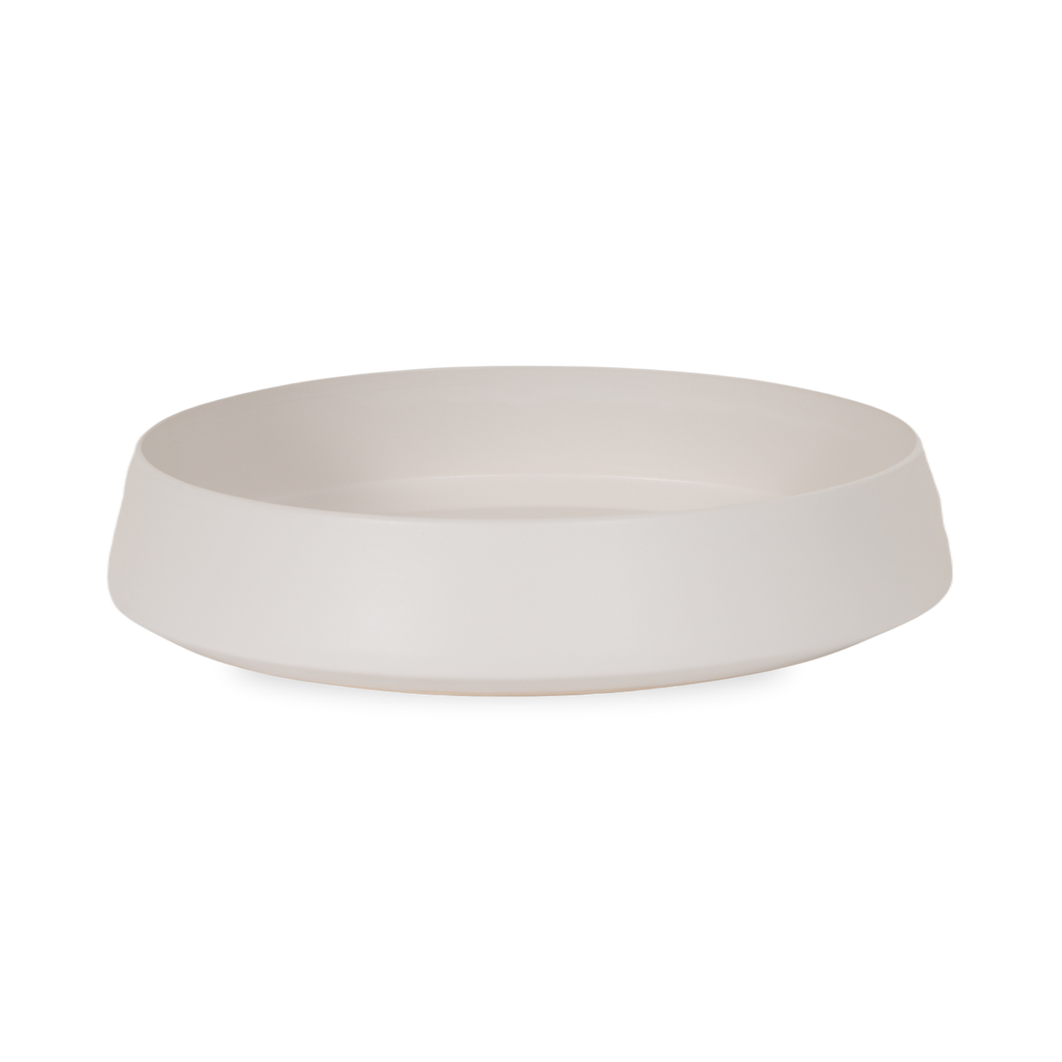 The Ceramic Serving Bowl features an elegant low-cut rounded body that is finished in a smooth matte white.